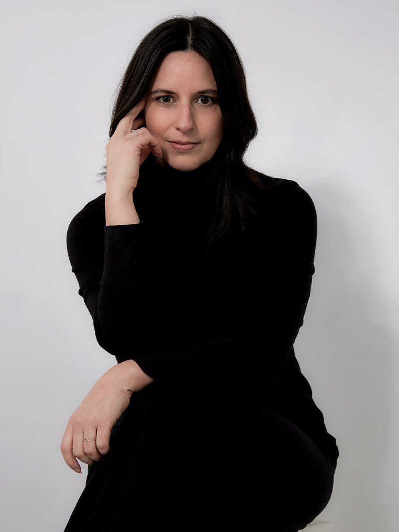 Kristina Dunn founder of RUA Beauty, wearing a black turtleneck against a plain background