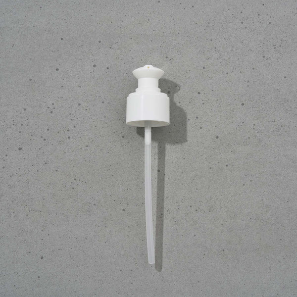 White plastic reusable pump on a gray background. To be used with Soothe, Hydrate, and Remove.